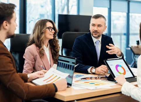 Business professionals discussing marketing strategy and financial reports in a
corporate meeting.