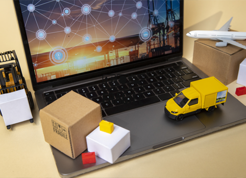 Digital logistics and supply chain concept with delivery truck, boxes, and global network on laptop.