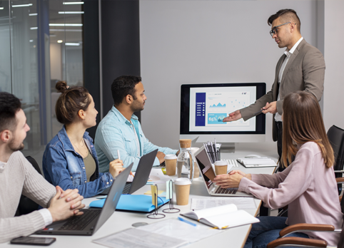 Digital marketing strategy meeting in office, team discussing SEO analytics, Google Ads performance, and social media growth reports during business presentation.